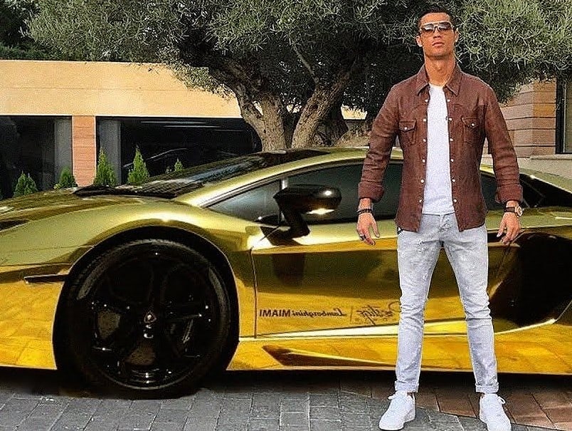 Cristiano Ronaldo alongside his golden Lamborghini Aventador LP 700-4