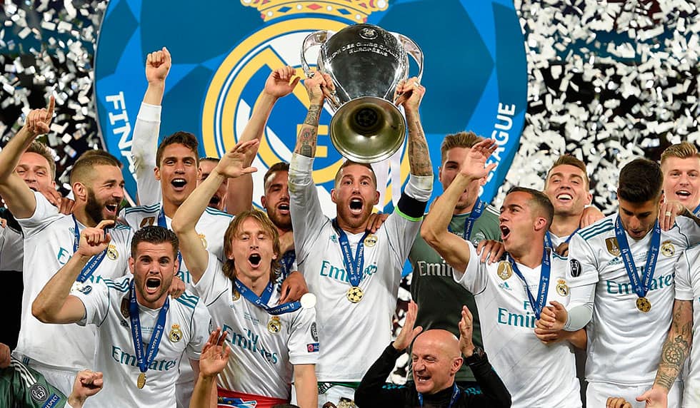 Real Madrid's Spanish defender Sergio Ramos (C) holds the trophy after winning the UEFA Champions League final football match between Liverpool and Real Madrid at the Olympic Stadium in Kiev, Ukraine on May 26, 2018. - Real Madrid defeated Liverpool 3-1. (Photo by LLUIS GENE / AFP) (Photo credit should read LLUIS GENE/AFP/Getty Images)