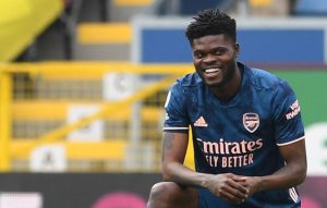 Thomas Partey of Arsenal takes a knee during the Premier League match between Burnley and Arsenal at Turf Moor on March 06, 2021 in Burnley, England. Sporting stadiums around the UK remain under strict restrictions due to the Coronavirus Pandemic as Government social distancing laws prohibit fans inside venues resulting in games being played behind closed doors. (Photo by David Price/Arsenal FC via Getty Images)