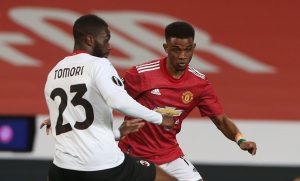 Amad of Manchester United in action with Fikayo Tomori of AC Milan during the UEFA Europa League Round of 16 First Leg match between Manchester United and A.C. Milan at Old Trafford on March 11, 2021 in Manchester, England. Sporting stadiums around the UK remain under strict restrictions due to the Coronavirus Pandemic as Government social distancing laws prohibit fans inside venues resulting in games being played behind closed doors. (Photo by Matthew Peters/Manchester United via Getty Images)